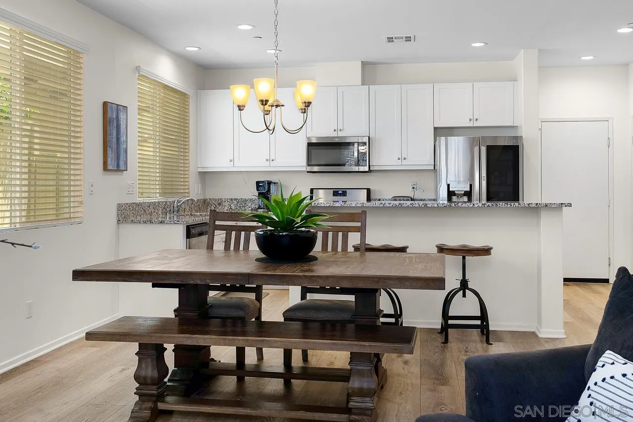 1290 Santa Victoria Road, Unit 2 Chula Vista, CA 91913 - Photo 8 of 41 a kitchen with cabinets table and chairs