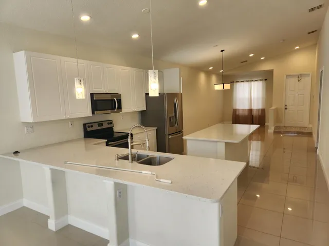 a kitchen with stainless steel appliances a refrigerator and a sink