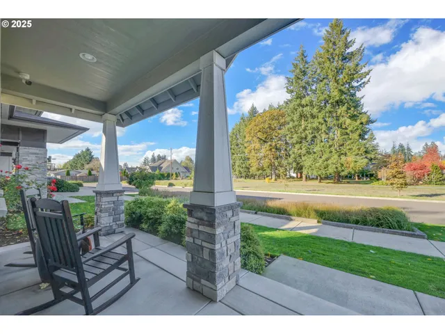 a view of a porch with furniture and garden