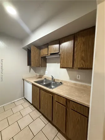 a kitchen with a sink and cabinets