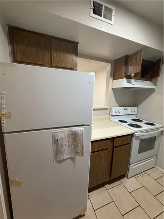 a kitchen with a stove and a refrigerator