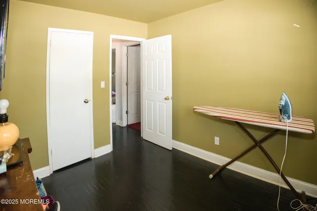 a view of a room with wooden floor