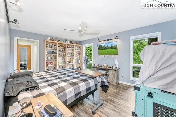 a bed sitting in a bedroom next to a window