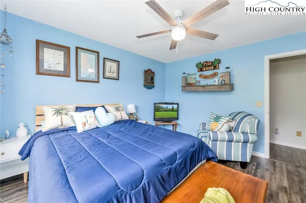 a bedroom with a bed and painting on the wall