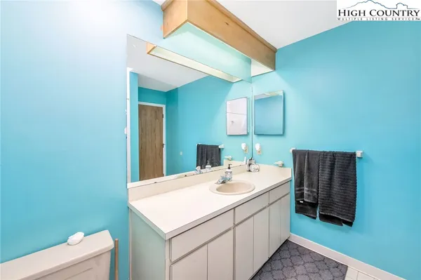 a bathroom with a sink a toilet and mirror