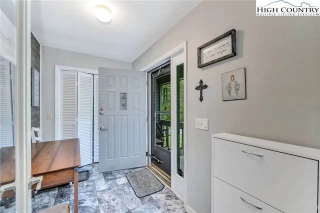 a view of room with window and hallway