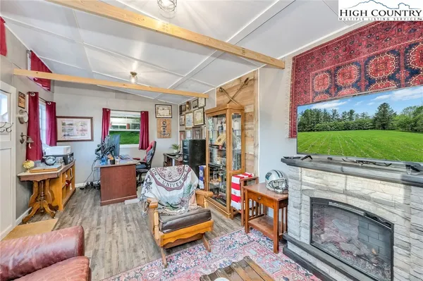 a living room with furniture a fireplace and a flat screen tv