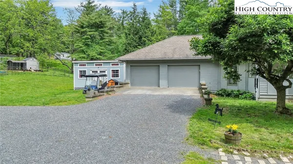 a view of a house with a backyard and a garden