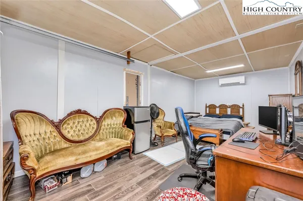 a view of a workspace with furniture and gym equipment