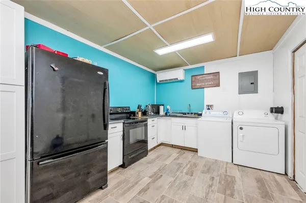 a kitchen with a sink cabinets stainless steel appliances and a window