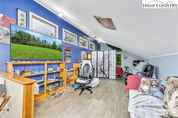 a view of a livingroom with workspace and a window