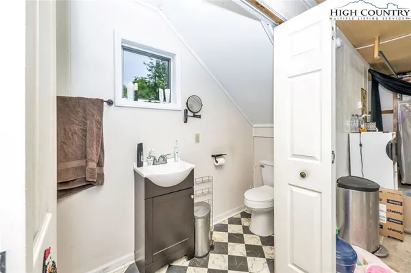 a bathroom with a sink mirror toilet and shower