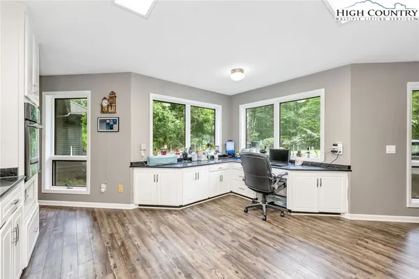 a living room with kitchen island granite countertop furniture and a large window