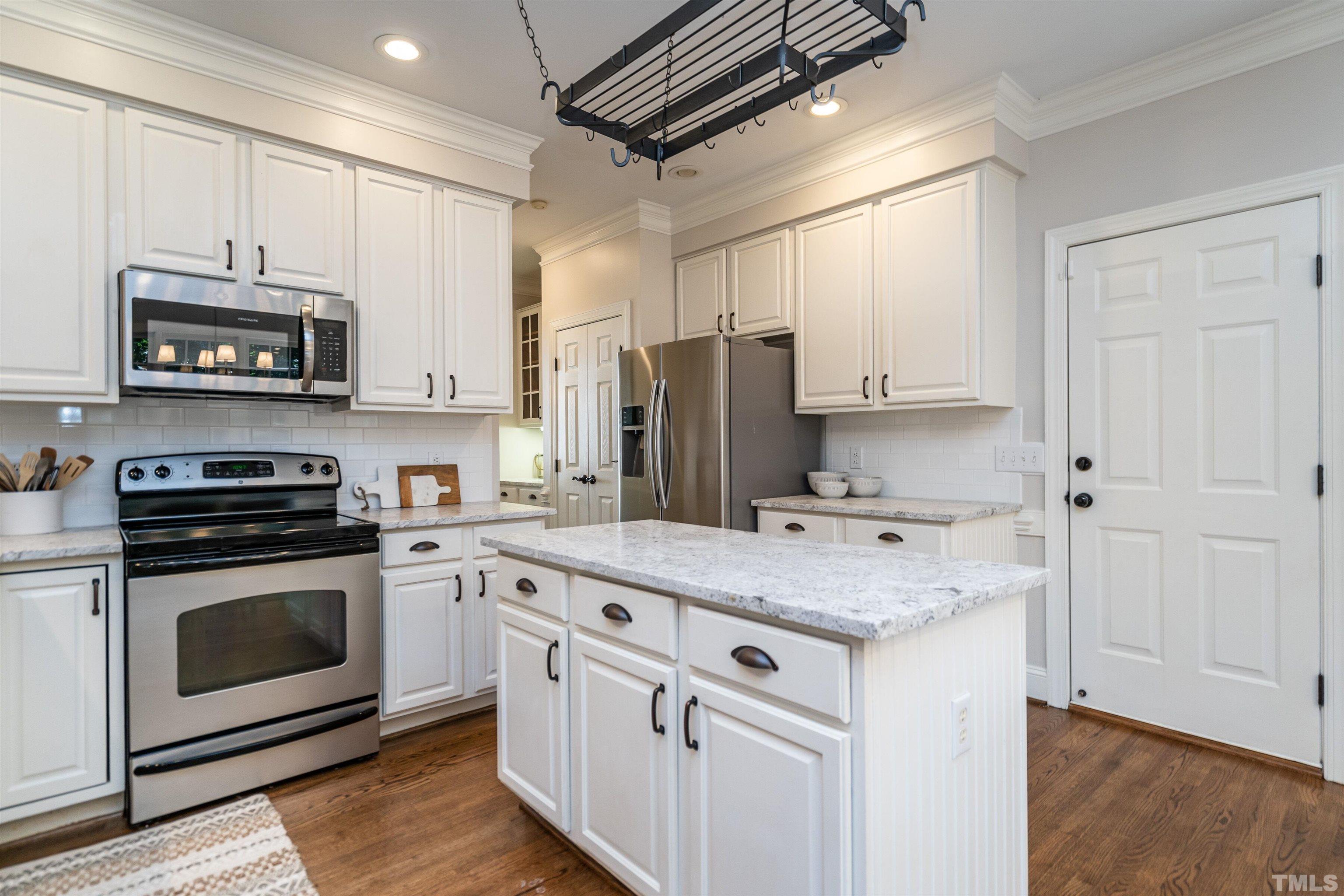 3016 Stone Gap Court Raleigh, NC 27612 - Photo 14 of 37 a kitchen with stainless steel appliances granite countertop a stove a sink and a refrigerator