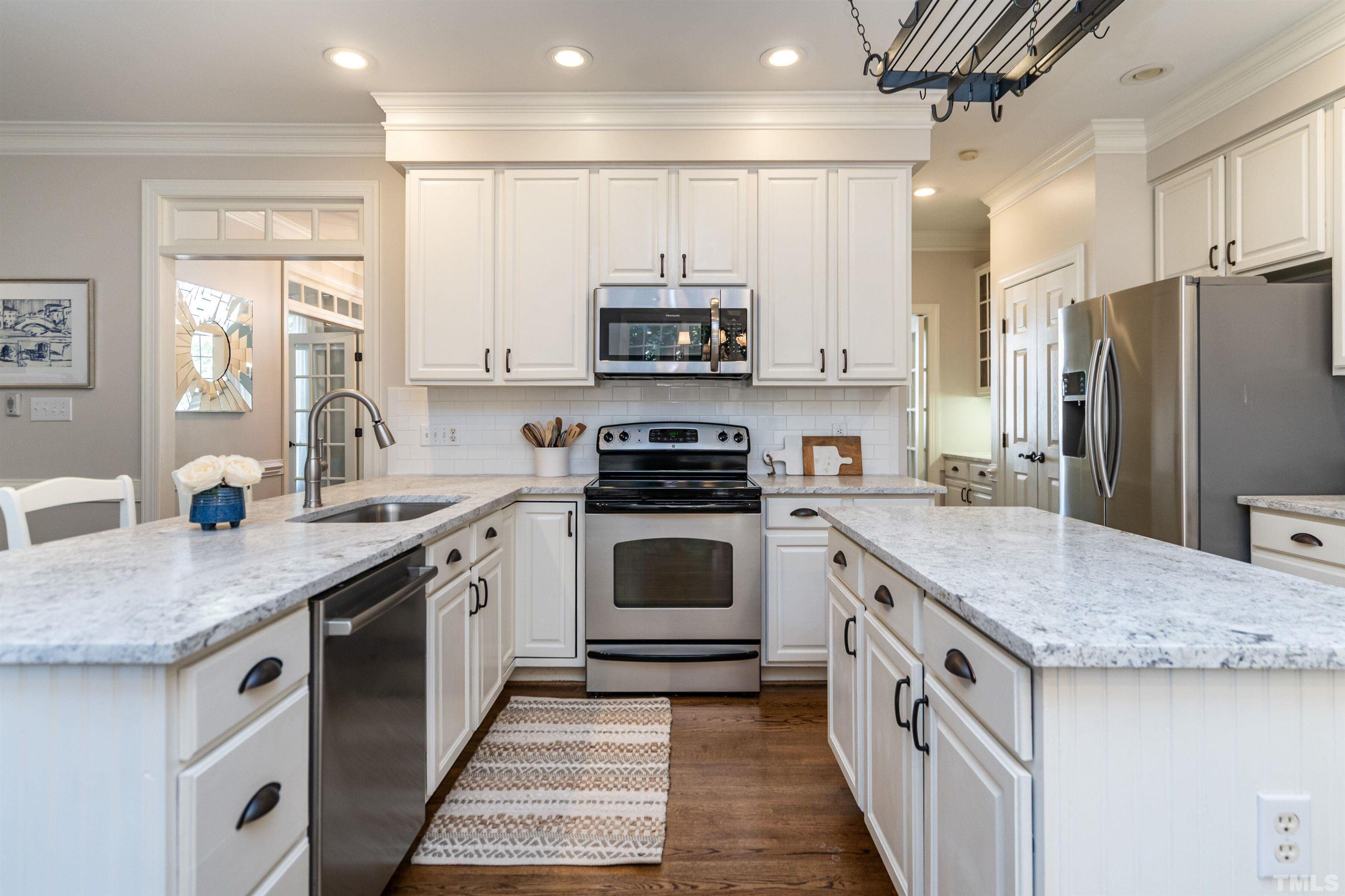 3016 Stone Gap Court Raleigh, NC 27612 - Photo 15 of 37 a kitchen with stainless steel appliances granite countertop a stove a sink and a refrigerator
