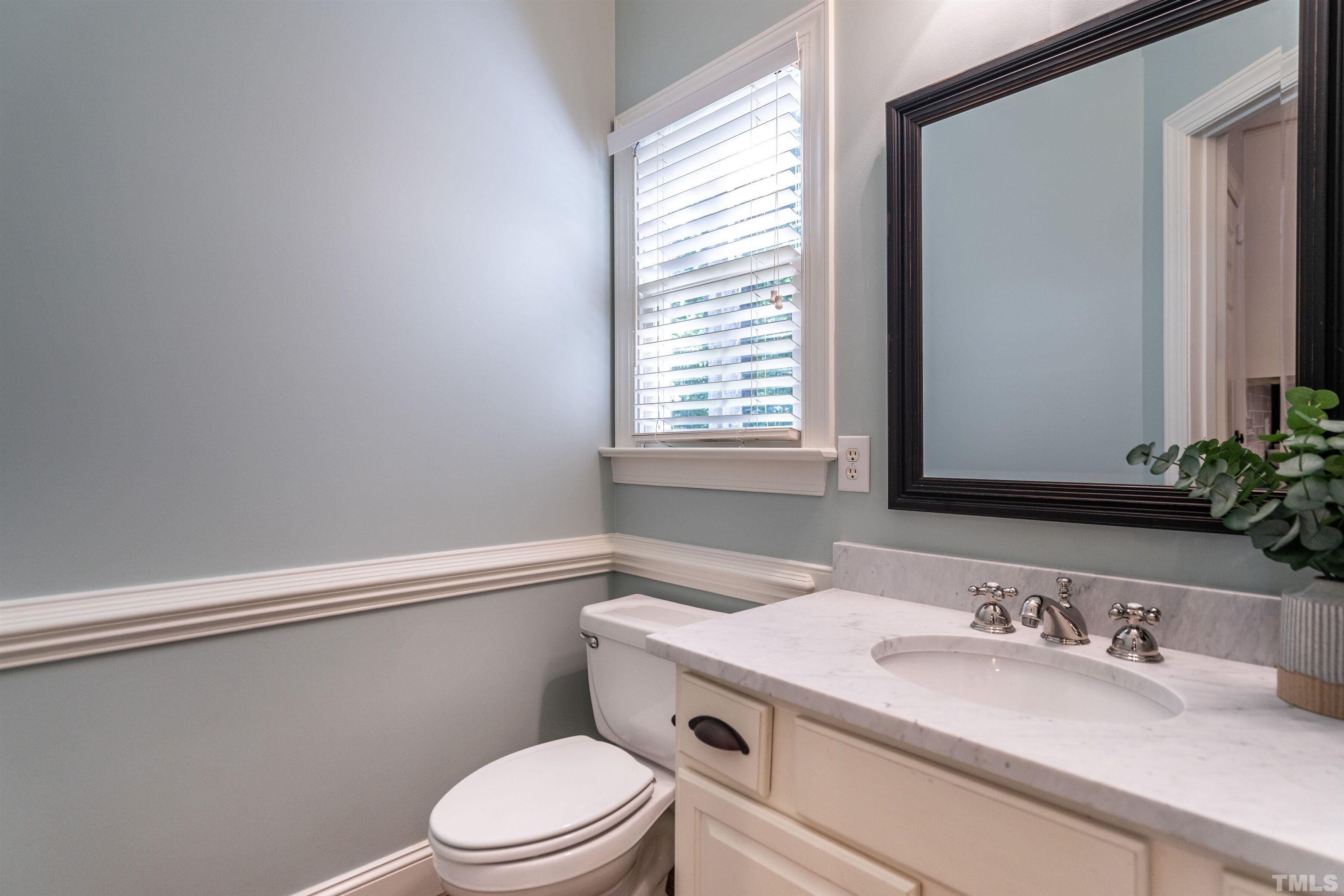 3016 Stone Gap Court Raleigh, NC 27612 - Photo 18 of 37 a bathroom with a granite countertop sink toilet a mirror and shower