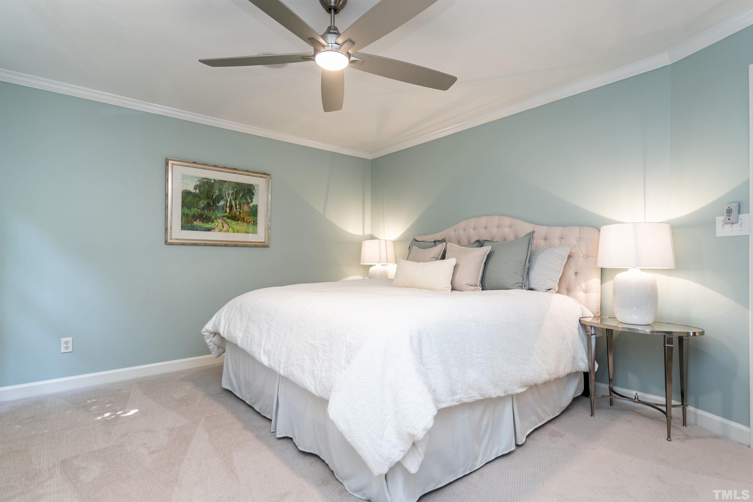 3016 Stone Gap Court Raleigh, NC 27612 - Photo 20 of 37 a bedroom with a bed and a chandelier