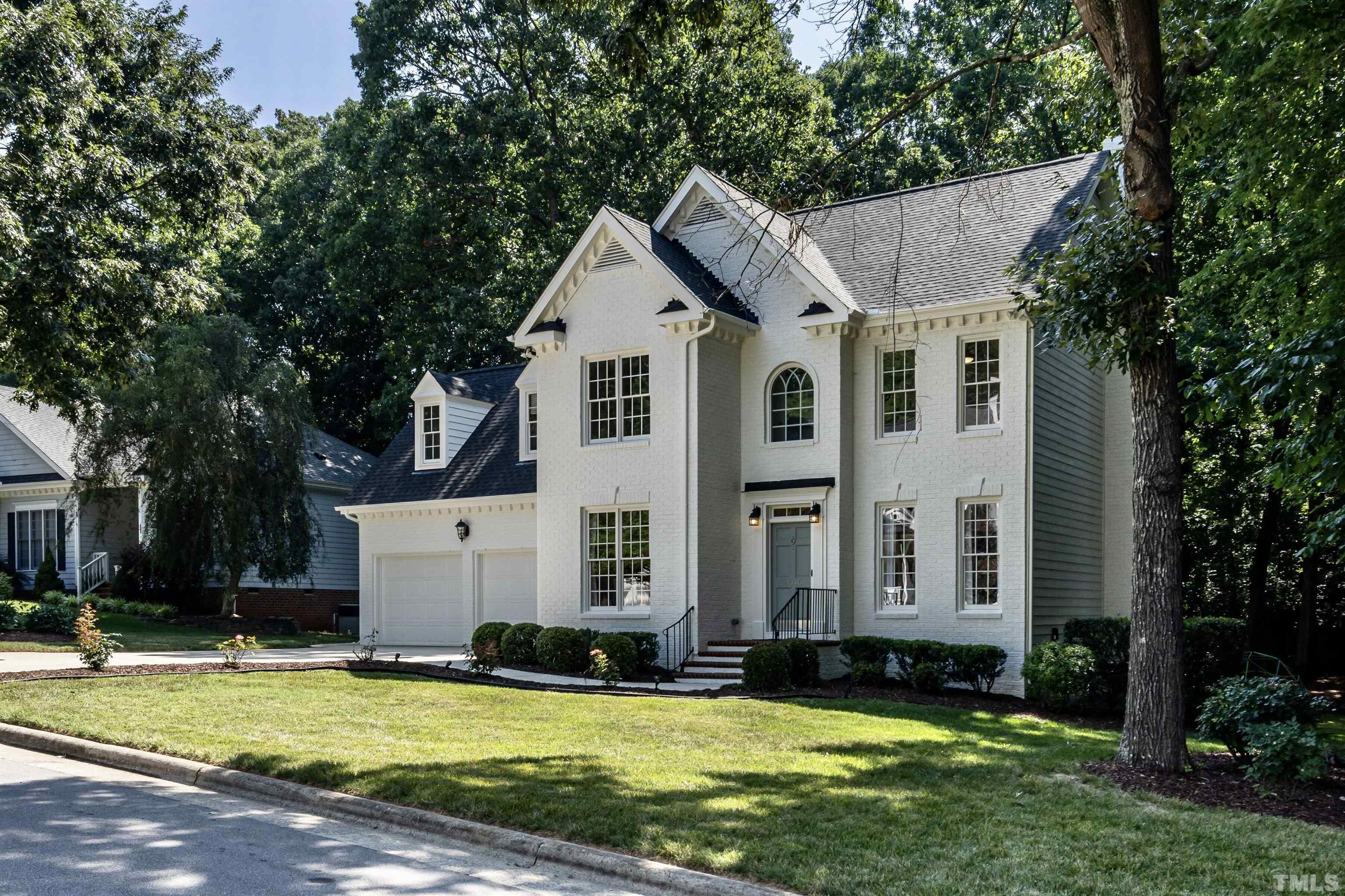 3016 Stone Gap Court Raleigh, NC 27612 - Photo 2 of 37 a view of a white house with a big yard and large trees