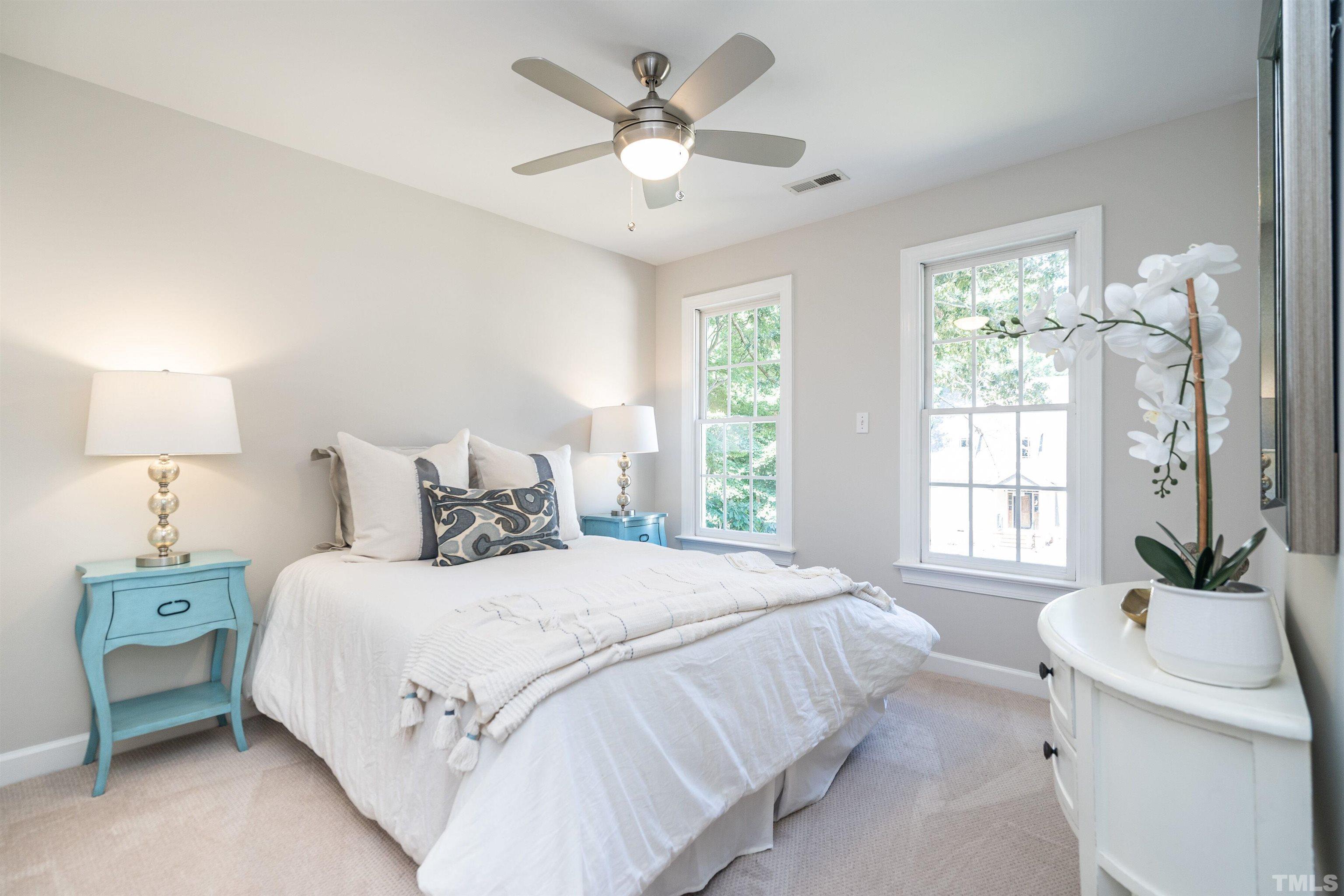 3016 Stone Gap Court Raleigh, NC 27612 - Photo 23 of 37 a bedroom with a bed and a chandelier