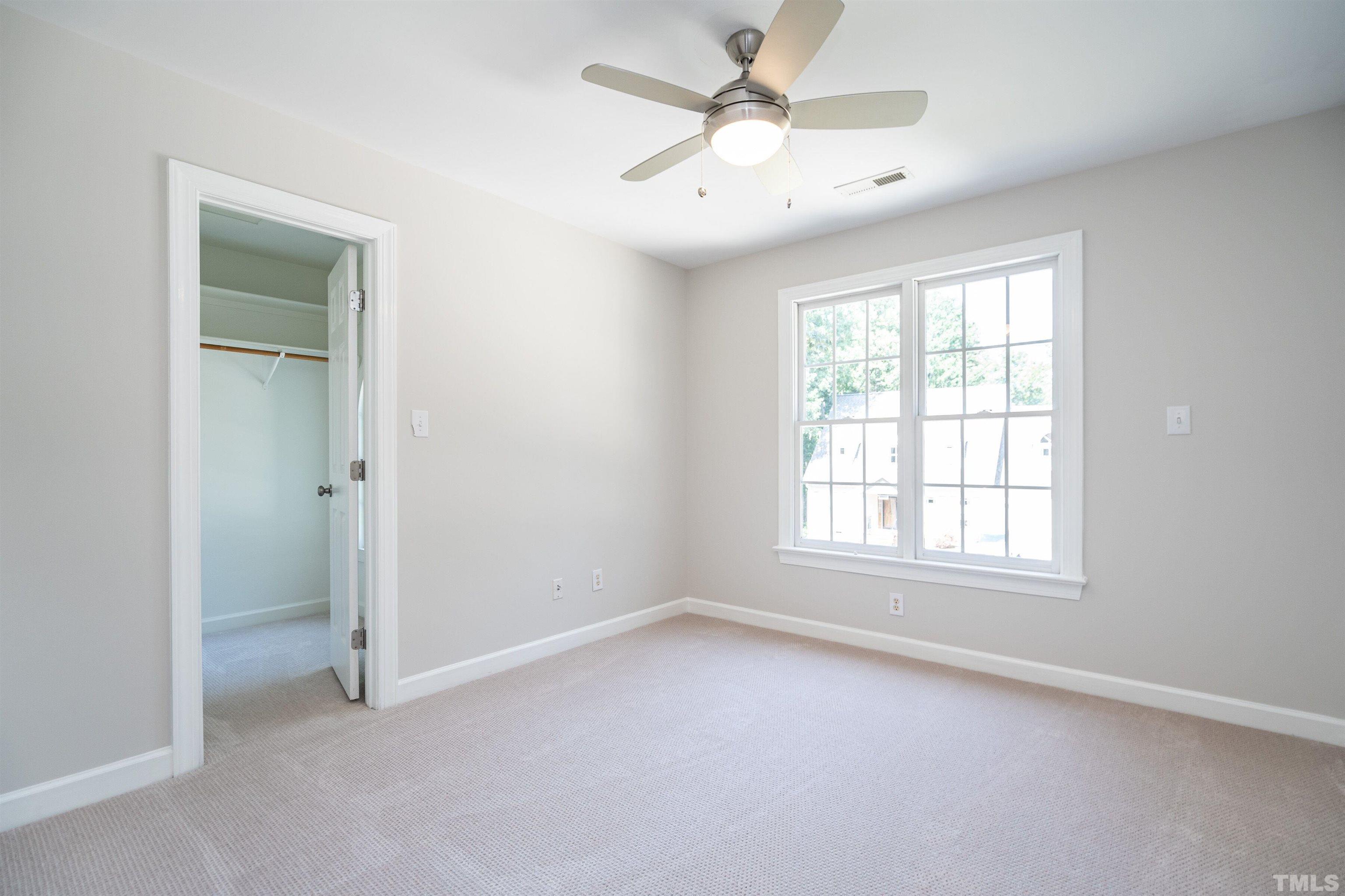 3016 Stone Gap Court Raleigh, NC 27612 - Photo 24 of 37 an empty room with chandelier fan and windows