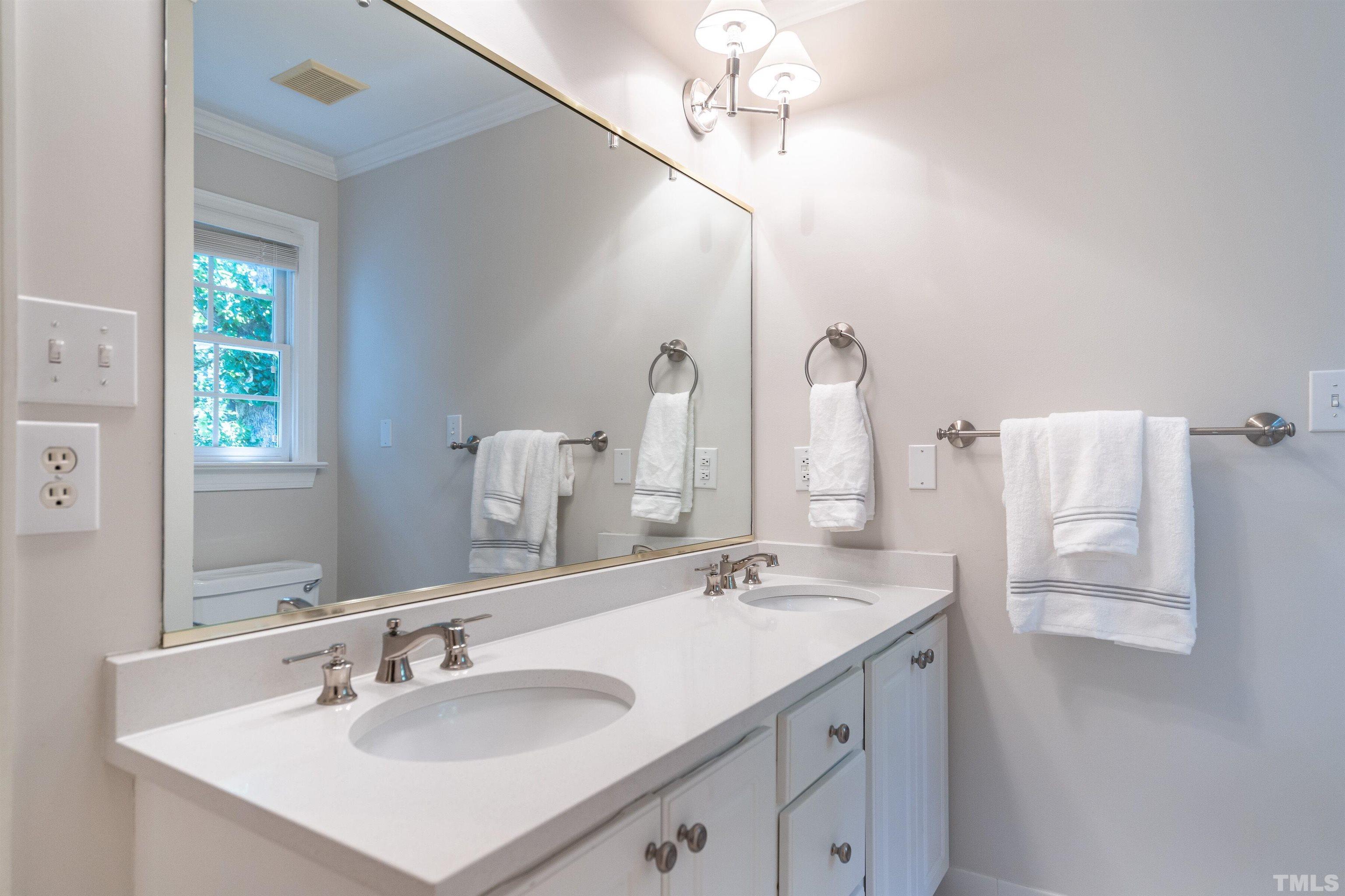 3016 Stone Gap Court Raleigh, NC 27612 - Photo 26 of 37 a bathroom with a sink and a mirror