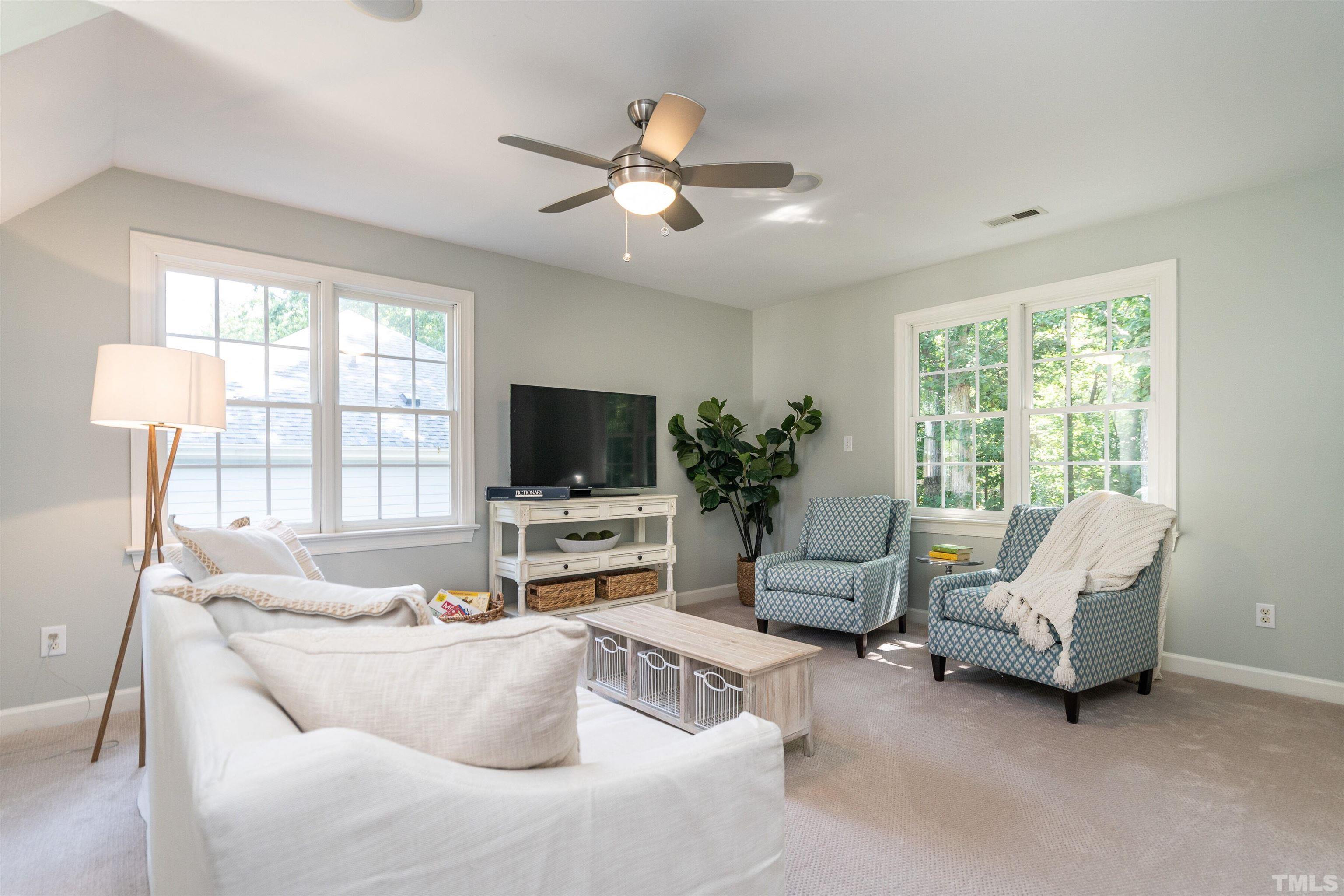 3016 Stone Gap Court Raleigh, NC 27612 - Photo 28 of 37 a living room with furniture and a flat screen tv