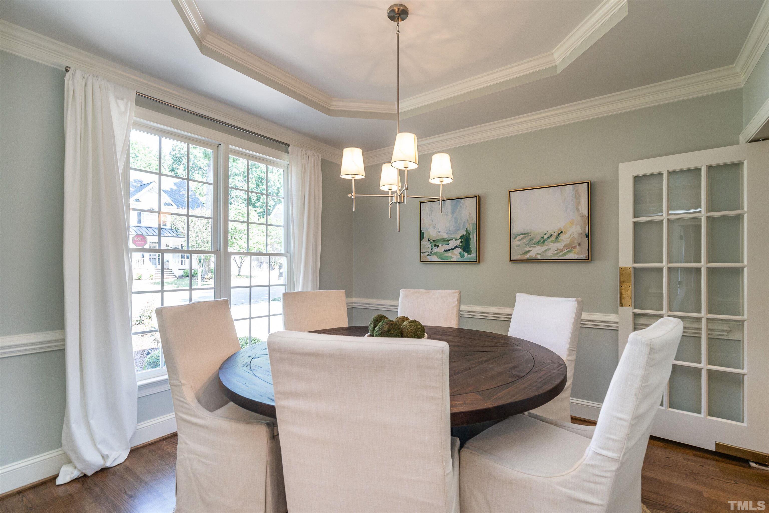3016 Stone Gap Court Raleigh, NC 27612 - Photo 6 of 37 a dining room with furniture a chandelier and wooden floor