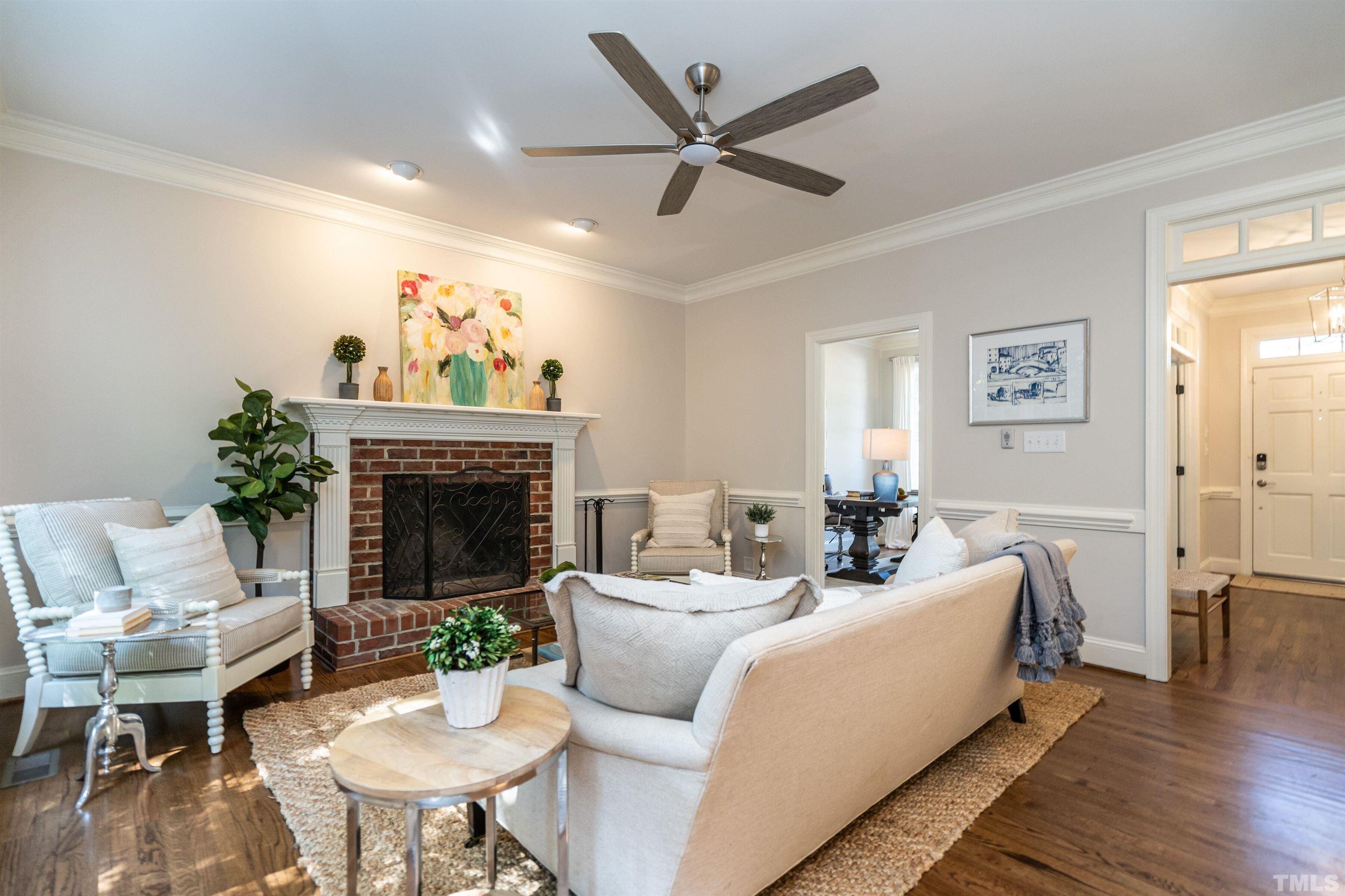 3016 Stone Gap Court Raleigh, NC 27612 - Photo 10 of 37 a living room with furniture a window and a fireplace