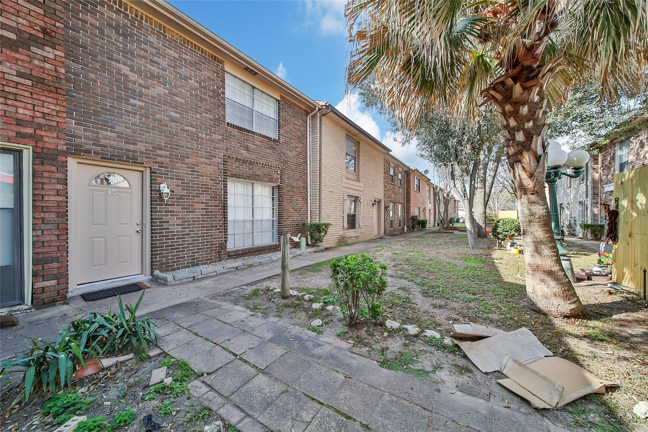 1403 Blalock Road, Unit 15 Houston, TX 77055 - Photo 2 of 21 a backyard of a house with potted plants and palm trees