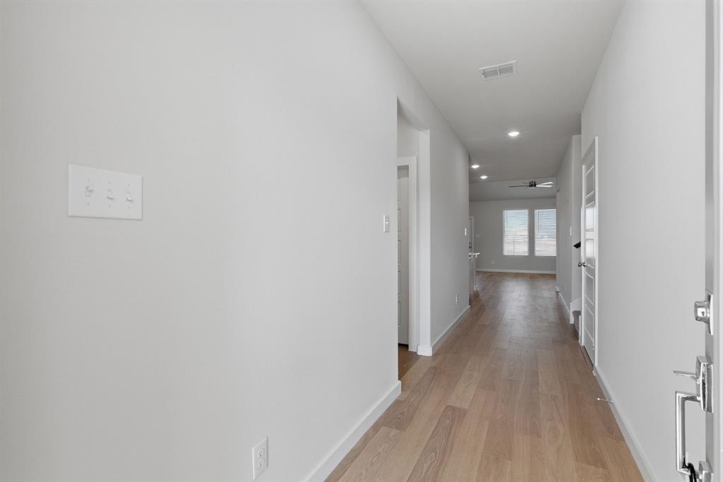 637 Sierra Ridge Lavon, TX 75166 - Photo 3 of 26 a view of a hallway with wooden floor