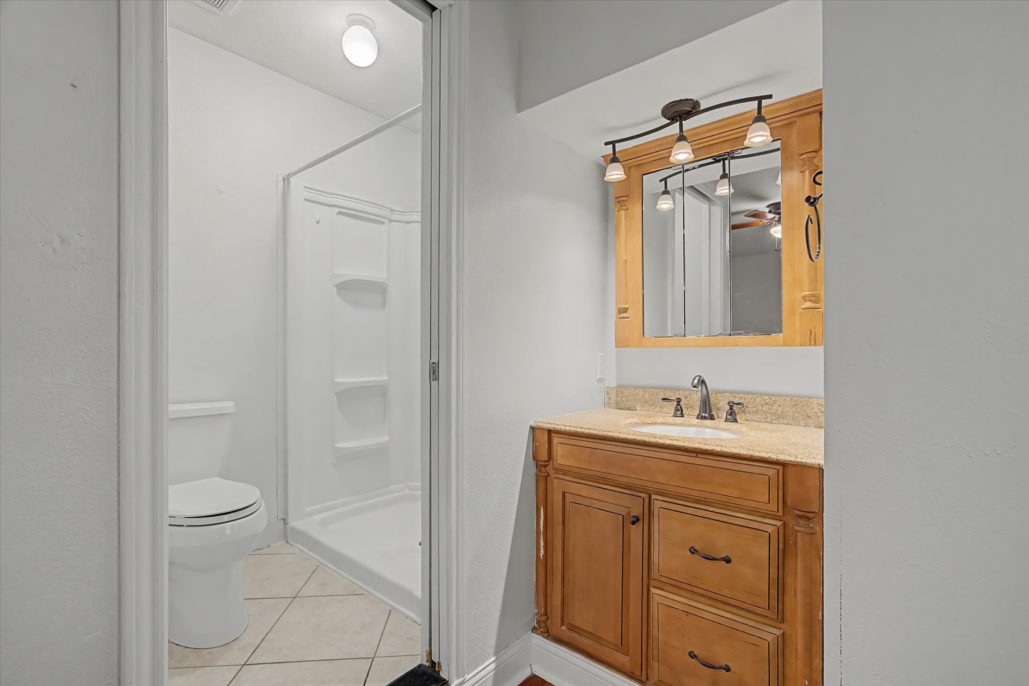 413 Farrer Street Angleton, TX 77515 - Photo 23 of 43 a bathroom with a toilet sink and mirror