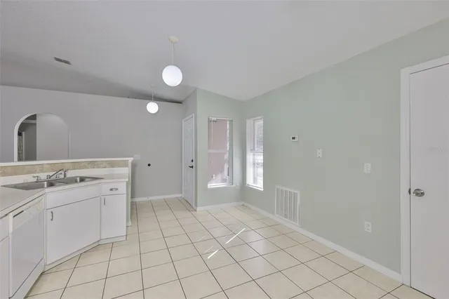 a view of a kitchen with white cabinets