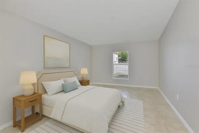 a bedroom with a bed and a night stand