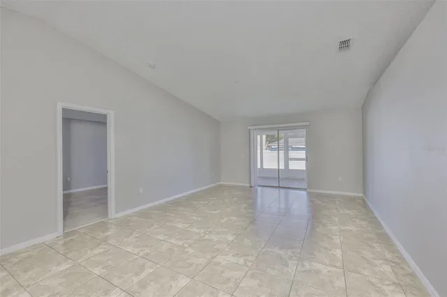 an empty room with windows and entrance