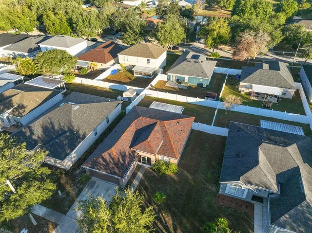 an aerial view of a residential houses with outdoor space