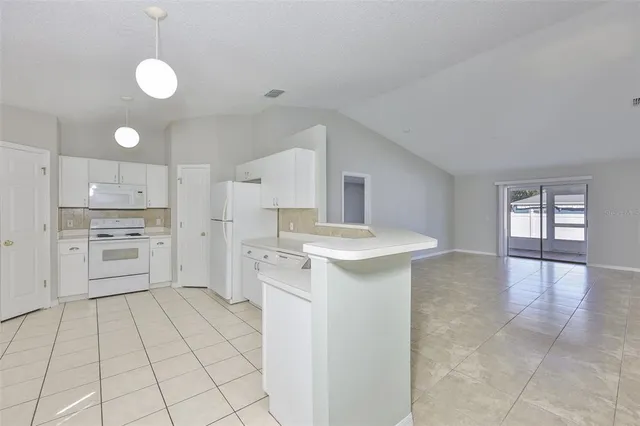 a kitchen with a sink cabinets and appliances