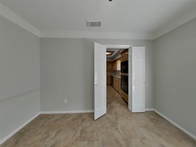 an empty room with closet and wooden door