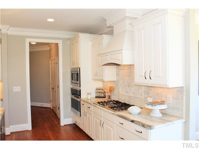 2613 Packhouse Road Zebulon, NC 27597 - Photo 11 of 25 Kenmore elite appliances tile backsplash with decorative inlay 5 burner natural gas cooktop and range hood convection oven.
