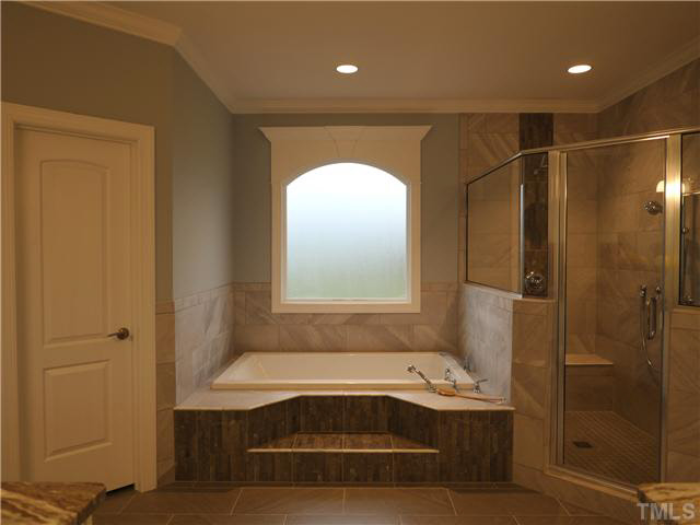 2613 Packhouse Road Zebulon, NC 27597 - Photo 19 of 25 Oversized shower with raindrop and wall mounted head seats beautiful decorative tile glamorous soaker tub.