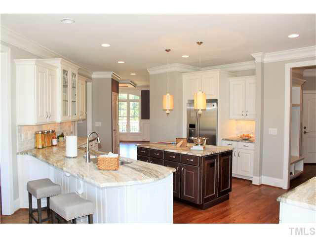 2613 Packhouse Road Zebulon, NC 27597 - Photo 10 of 25 Award winning kitchen with exotic granite counter tops tile backsplash cherry island raised panel glazed cabintets