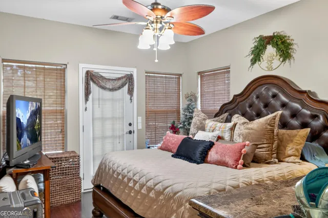 a bedroom with a bed and a flat screen tv