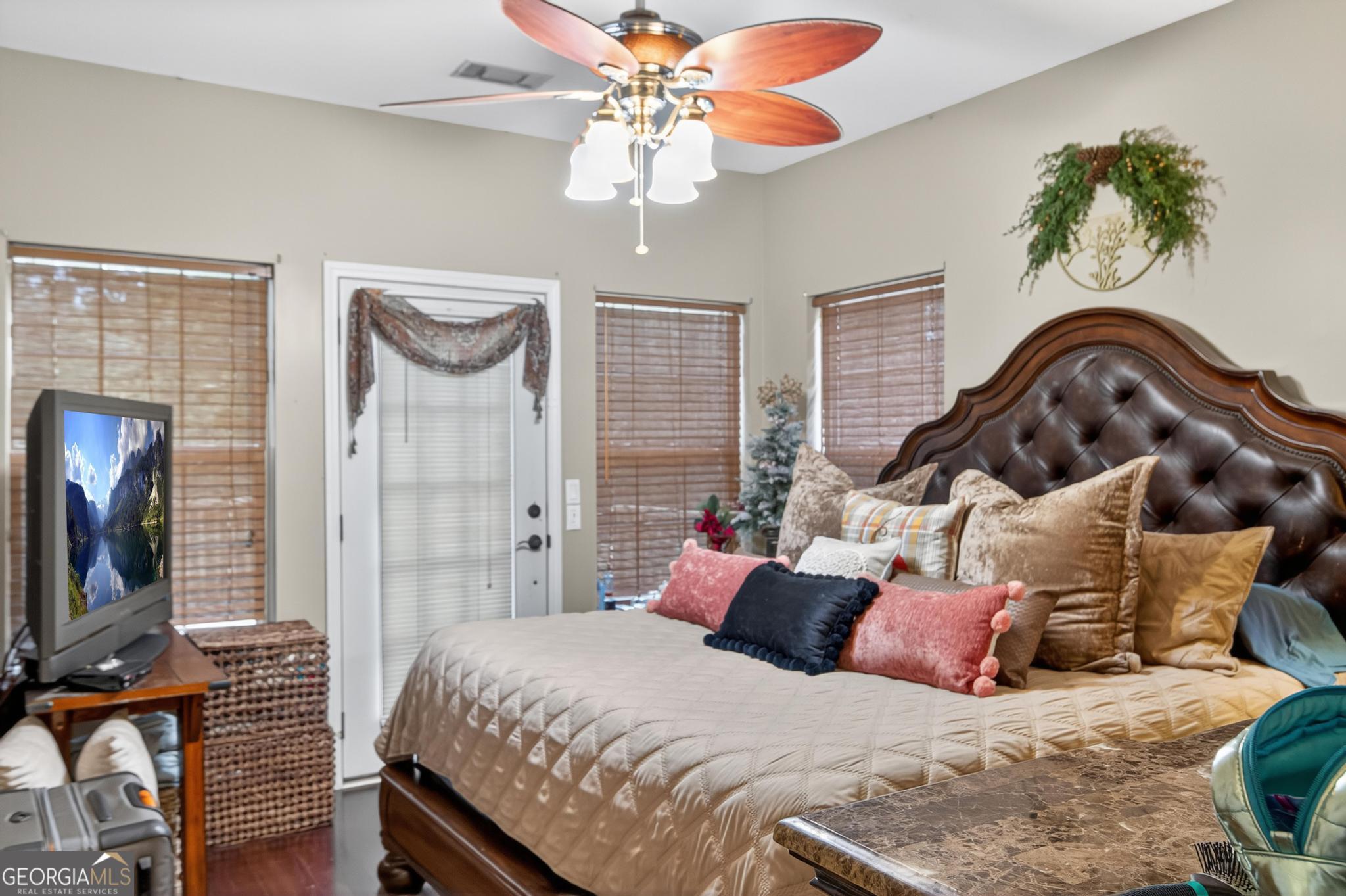 363 Dover Road Sylvania, GA 30467 - Photo 11 of 27 a bedroom with a bed and a flat screen tv