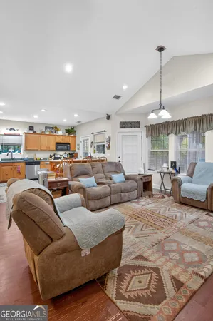 a living room with furniture and a chandelier