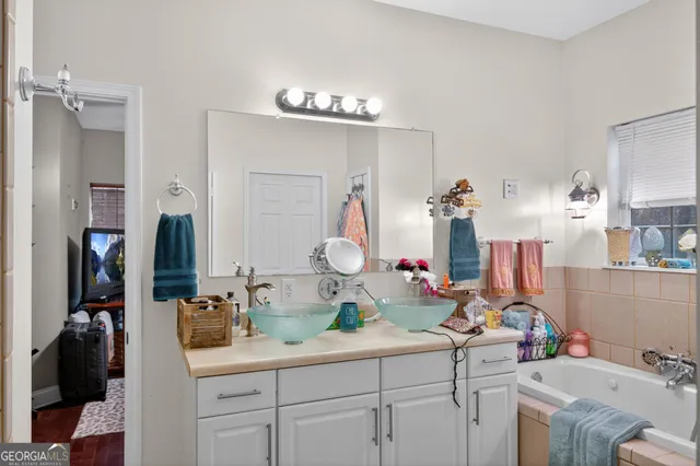 a bathroom with a sink mirror and vanity