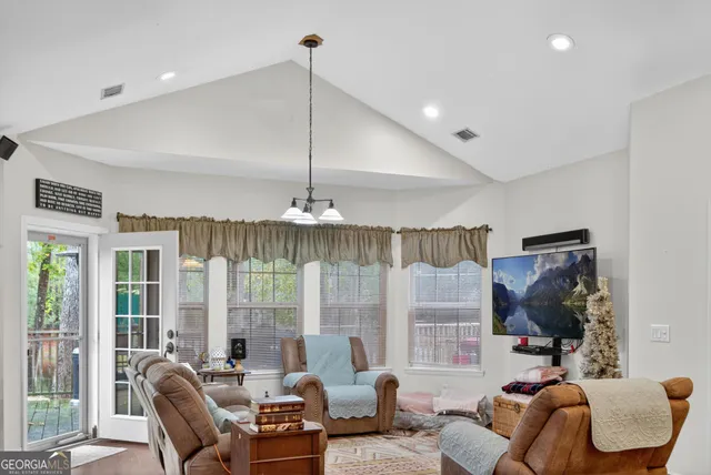 a living room with furniture and a chandelier