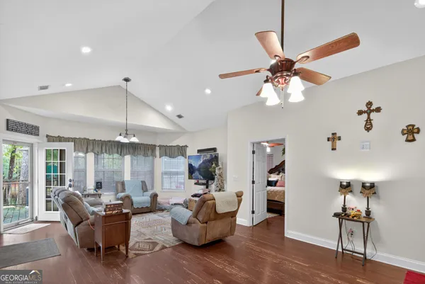 a living room with furniture and a chandelier
