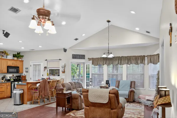 a living room with fireplace furniture and a chandelier