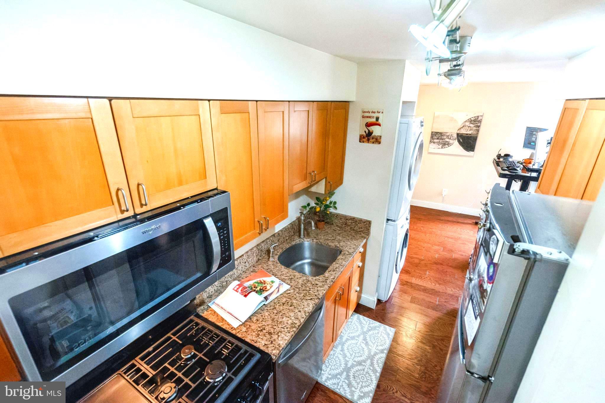 11232 Chestnut Grove Square, Unit 334 Reston, VA 20190 - Photo 11 of 31 Washer and Dryer on outside of kitchen.