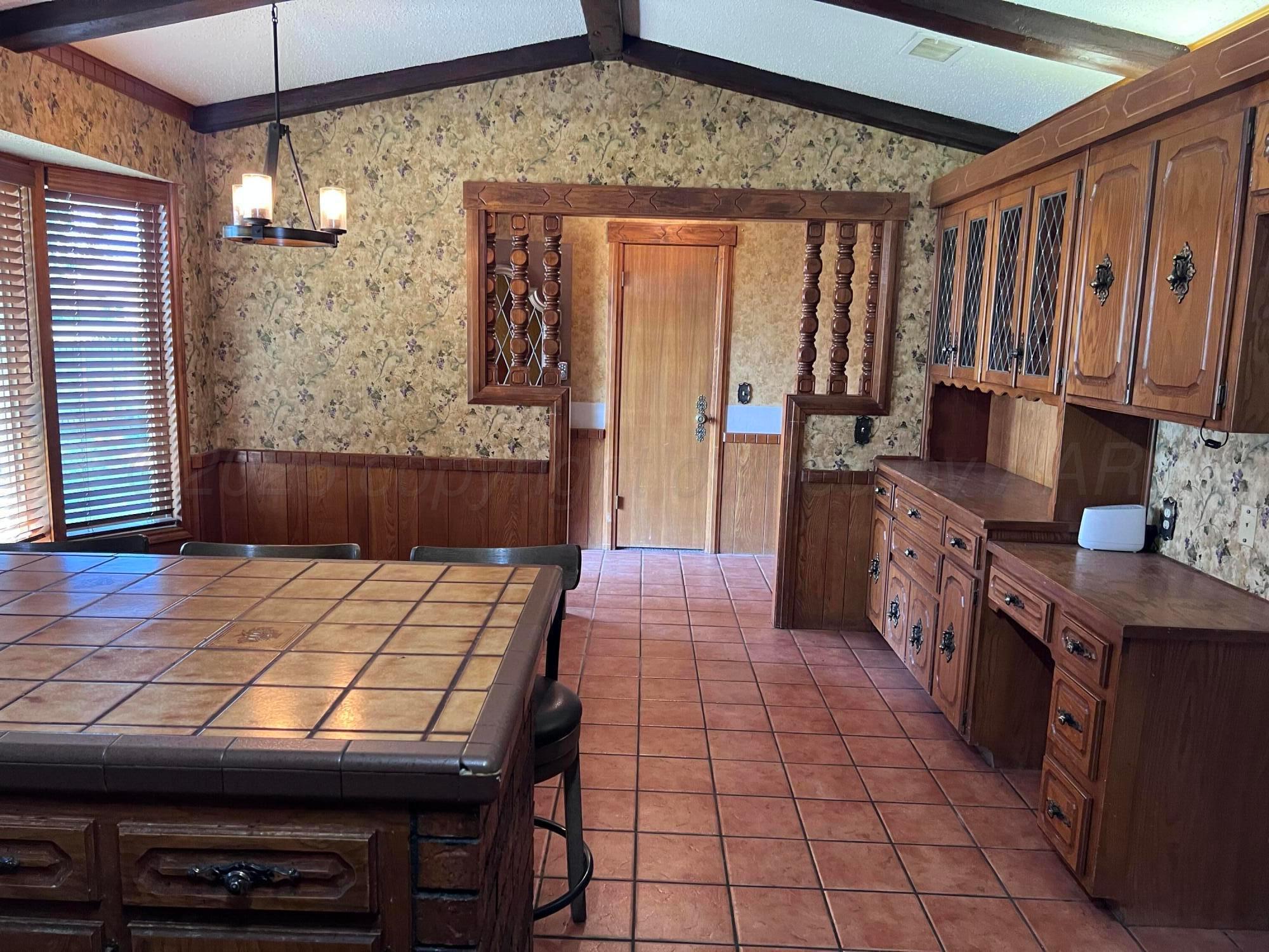 807 North Arrah Friona, TX 79035 - Photo 11 of 56 a kitchen with a wooden floor and a refrigerator