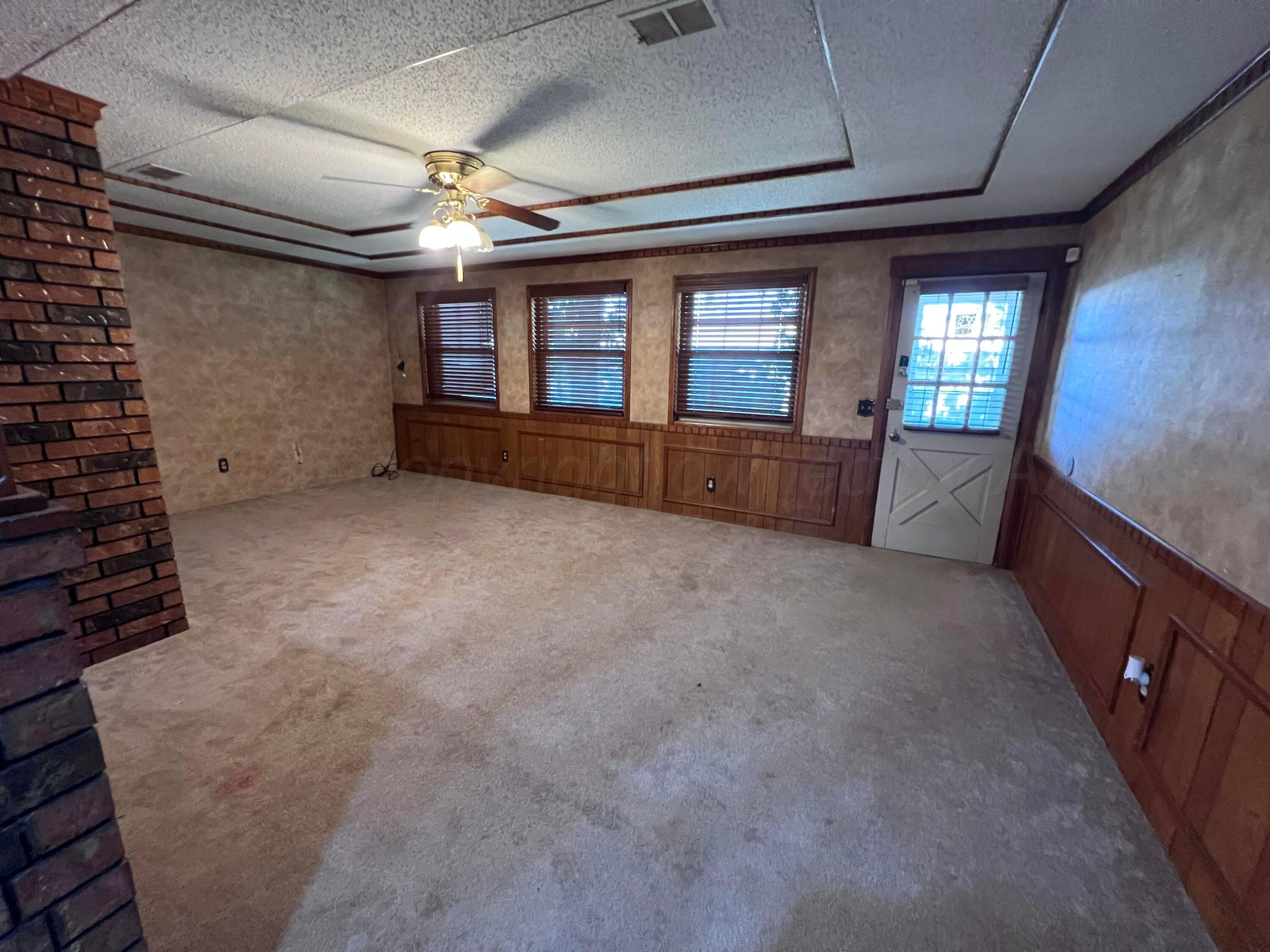 807 North Arrah Friona, TX 79035 - Photo 19 of 56 a living room with furniture and a flat screen tv